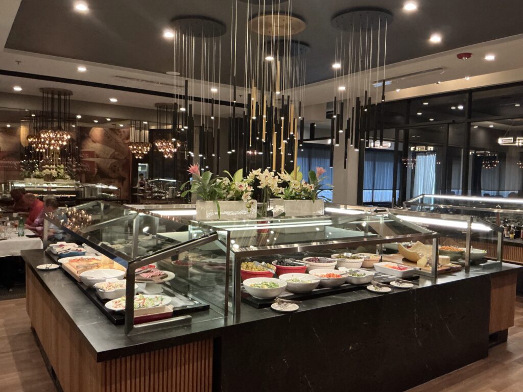 Gourmet salad bar at Chama Gaucha Houston featuring fresh salads, vegetables, cheeses, and colorful sides.