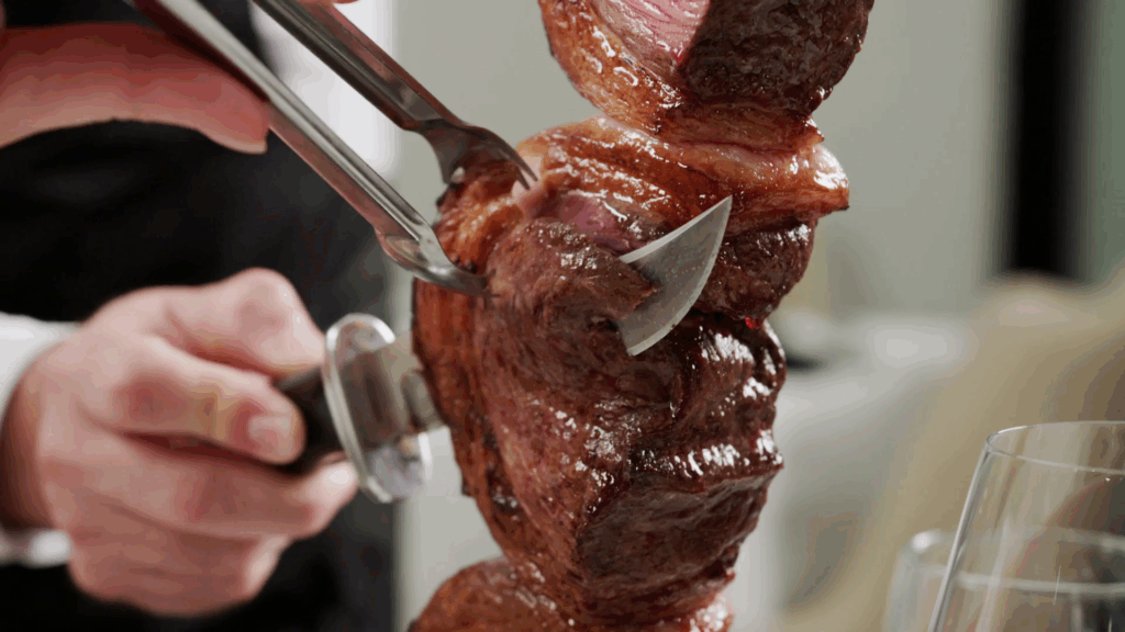 Gaucho serving picanha tableside at Chama Gaucha Brazilian steakhouse