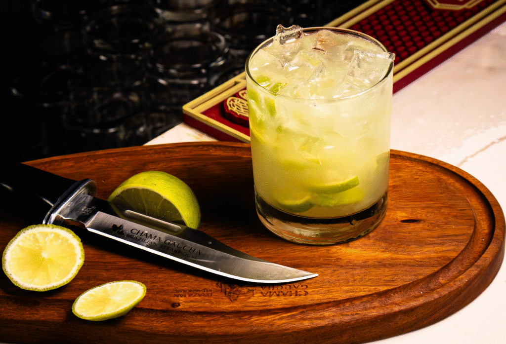 Brazilian caipirinha cocktail with fresh lime and ice.