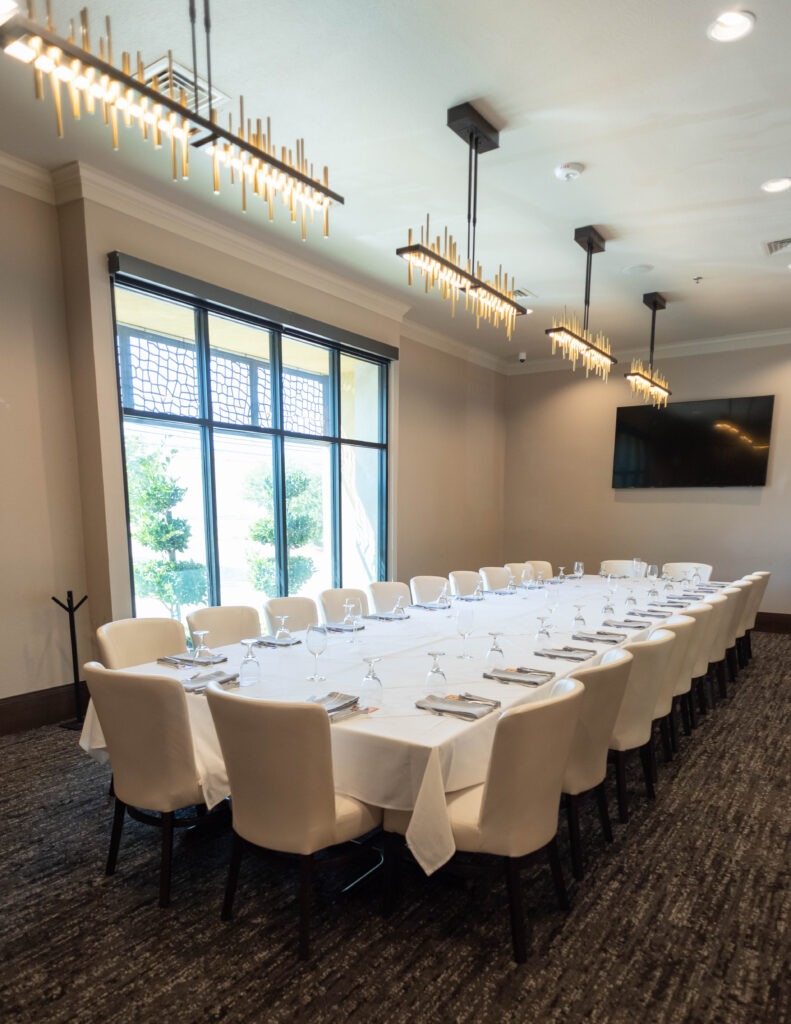 Corner view of a private dining room at Chama Gaucha Dallas with formal table setup